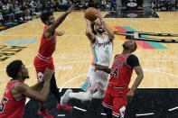 San Antonio Spurs guard Derrick White (4) drives to the basket against Chicago Bulls forward Javonte Green (24) during the first half of an NBA basketball game, Friday, Jan. 28, 2022, in San Antonio. (AP Photo/Eric Gay)