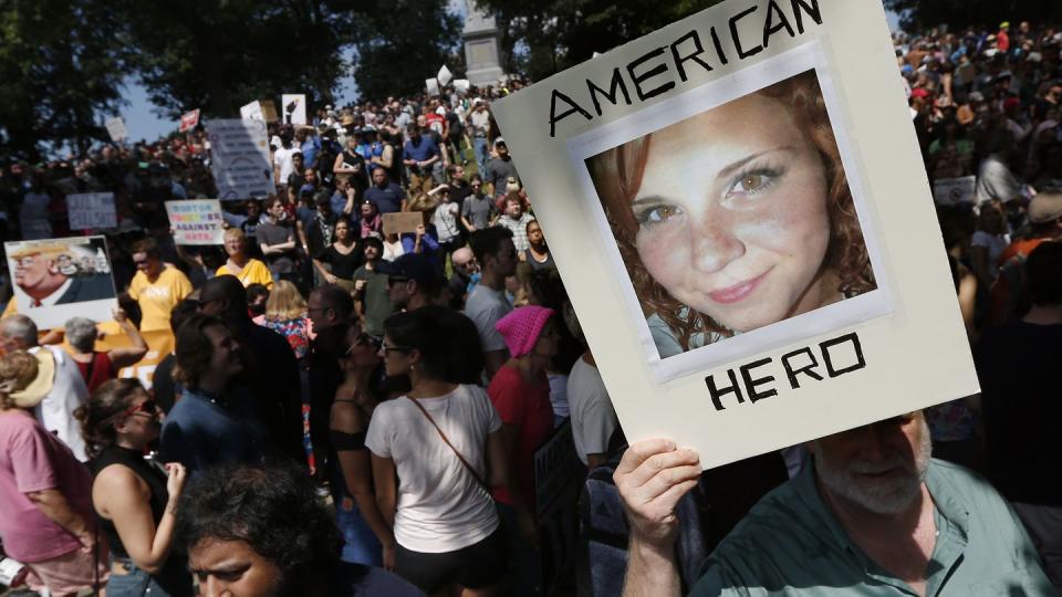 A protester holds a photo of Heather Heyer, a counterprotester killed at the Unite the Right rally in Charlottesville, Va. in 2017. James Alex Fields Jr., a white supremacist who killed Heyer, is serving a life sentence. (AP Photo/Michael Dwyer, File)