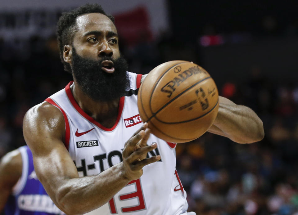 FILE - In this Saturday, March 7, 2020, file photo, Houston Rockets guard James Harden passes against the Charlotte Hornets during the second half of an NBA basketball game in Charlotte, N.C. Harden practiced with his teammates for the first time this summer, Thursday, July 16, 2020, after arriving later than most of the Rockets for the season restart at Walt Disney World. (AP Photo/Nell Redmond, File)