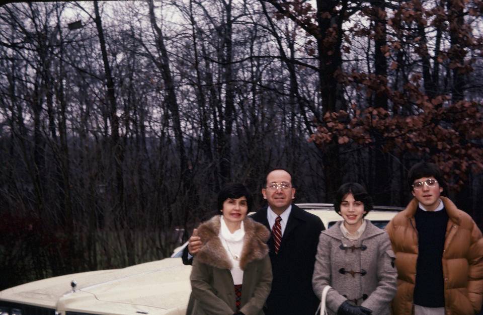 In this photo provided by D'Innocenzio Family Collection, Anne D'Innocenzio, third from left, her late parents Michael and Marie D'Innocenzio and her late brother Robert pose in the back of the family's childhood home in the late 1970s, in suburban New Jersey. D'Innocenzio said, "After mom's passing in February 2023, my sister and I quickly made a plan to honor her wishes: what to keep, which items to give to relatives and friends, which to donate and what to discard." (D'Innocenzio Family Collection via AP)