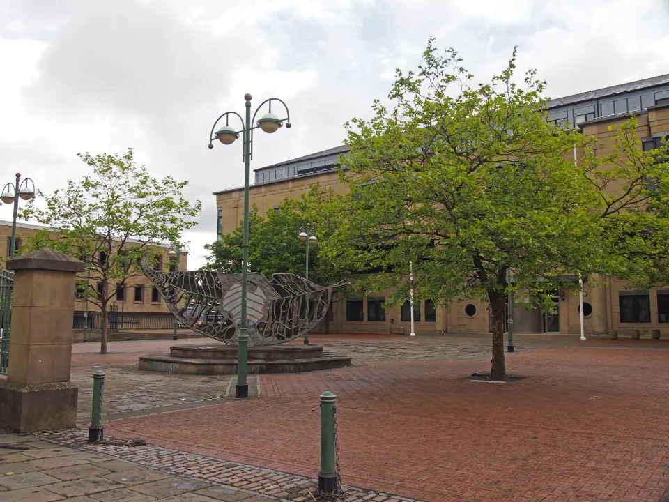 bradford, west yorkshire, united kingdom - 28 may 2019: a view of exchange square in bradford west yorkshire with the crown court building surrounded by trees