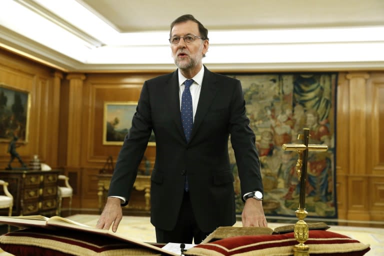 Spain's newly re-elected Prime Minister Mariano Rajoy swears an oath during a royal decree ceremony at the Zarzuela Palace in Madrid on October 31, 2016