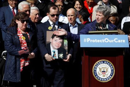 Kim Goodloe, who's family has benefited from Obamacare, speaks at an event marking the seventh anniversary of the passing of the Affordable Care Act outside the Capitol Building in Washington, U.S., March 22, 2017. REUTERS/Aaron P. Bernstein