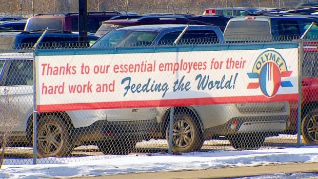 A sign outside the Olymel pork plant in Red Deer, Alta., thanks the company's essential employees. It will reopen on Thursday, after being closed since Feb. 15 due to a COVID-19 outbreak.