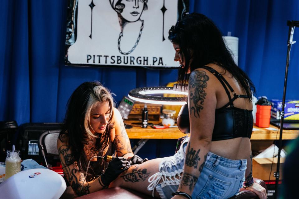 Ari Mastellino works on a tattoo during the 2023 INKcarceration Music & Tattoo Festival in Mansfield.