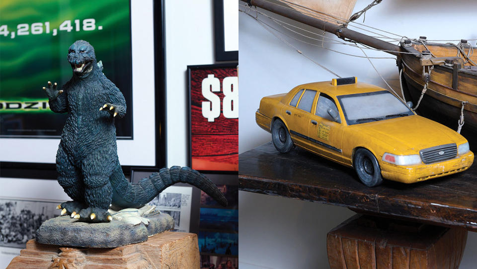 Left: A Godzilla toy sits next to a poster touting the film’s first-week’s gross leading to Memorial Day 1998. Right: Despite not wanting to make Godzilla, several props (including this model cab) from the film linger in his workspace. - Credit: Photographed by Yasara Gunawardena