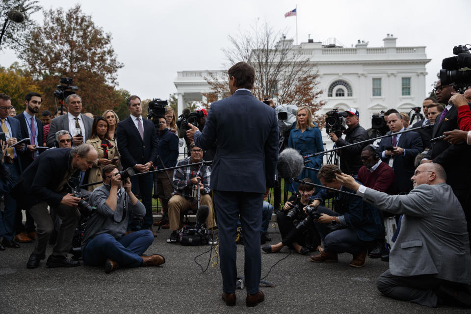 White House deputy press secretary Hogan Gidley talks with reporters outside the White House, Tuesday, Oct. 22, 2019, in Washington. (AP Photo/Evan Vucci)