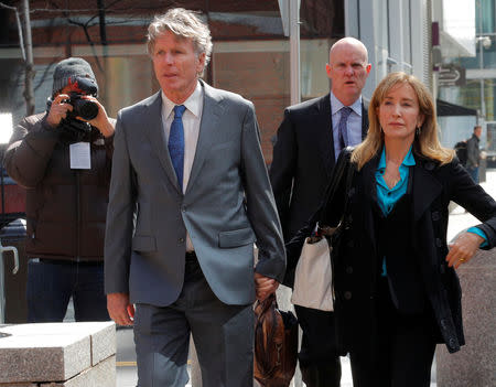 FILE PHOTO: Actor Felicity Huffman, facing charges in a nationwide college admissions cheating scheme, accompanied into federal court in Boston, Massachusetts, U.S., April 3, 2019. REUTERS/Brian Snyder