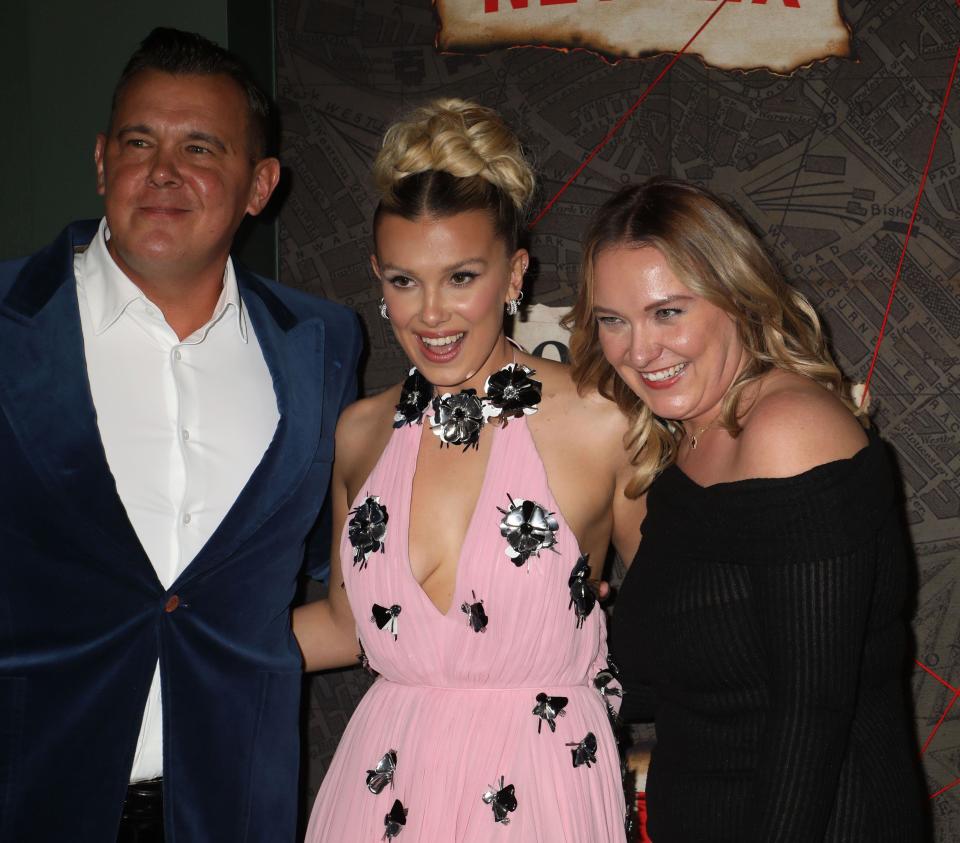 Millie Bobby Brown with her parents Robert and Paige Brown. (Alamy)