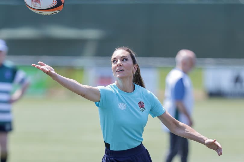 Catherine, Princess of Wales takes part in drills on the pitch during her visit to Maidenhead Rugby Club