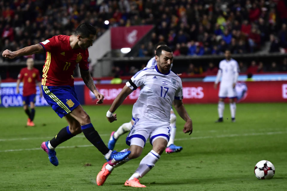 Spain's Vitolo, left, takes a shot on goal and shoots past Israel's Shir Tzedek during a 2018 World Cup Group G qualifying soccer match between Spain and Israel, at El Molinon Stadium, in Gijon, northern Spain, Friday, March 24, 2017. (AP Photo/Alvaro Barrientos)