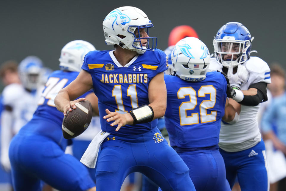 FILE - South Dakota State quarterback Mark Gronowski (11) looks to pass during the first half of an NCAA college football game against Drake, Saturday, Sept. 16, 2023, in Minneapolis. Gronowski and Monmouth running back Jaden Shirden, both finalists for the Walter Payton Award given to the most outstanding player in the Championship Subdivision, were selected to the Associated Press FCS All-America team announced Tuesday, Dec. 12, 2023. (AP Photo/Abbie Parr, File)