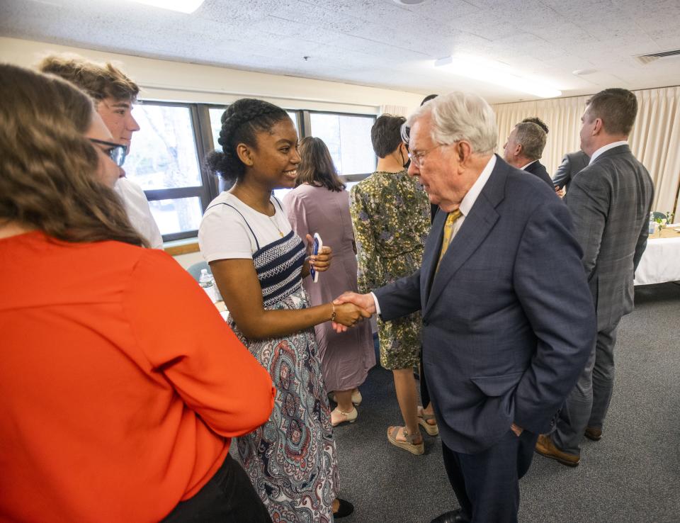 President M. Russell Ballard greets Lauren Hunting, Beckham Elwell and Briana Vilme during a multi-stake youth fireside in Georgetown, Massachusetts.