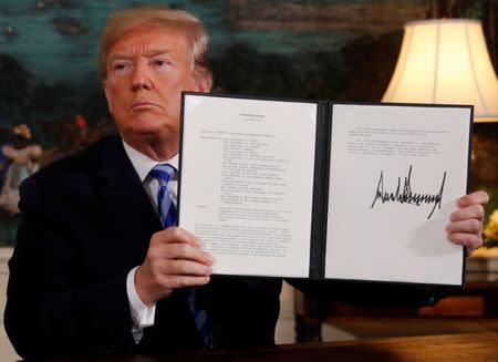 U.S. President Donald Trump displays a presidential memorandum after announcing his intent to withdraw from the JCPOA Iran nuclear agreement in the Diplomatic Room at the White House in Washington, U.S., May 8, 2018. REUTERS/Jonathan Ernst/Files