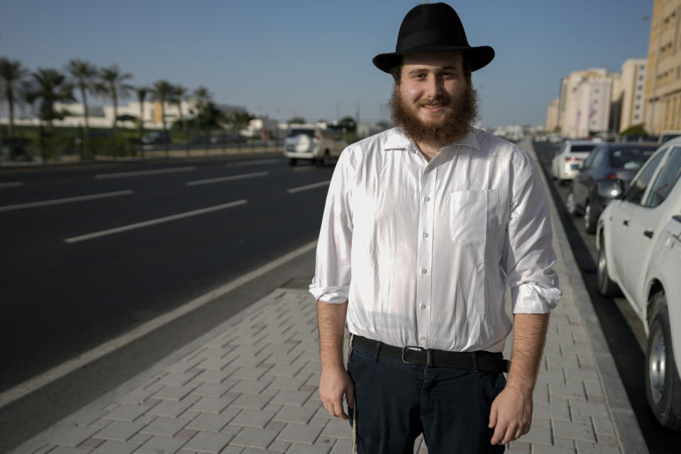 Eli Chitrik from Turkey poses for photos outside his hotel in Doha, Qatar, Monday, Nov. 28, 2022. Stored into bright orange cases in Rabbi Eli Chitrik’s hotel room are bagels stuffed with vegetables. The labels declare the sandwiches kosher, or in compliance with Judaism’s set of dietary regulations. Freshly baked, they are made in Qatar at a designated kitchen, set up to feed Jewish World Cup visitors who want to keep kosher during the tournament. (AP Photo/Moises Castillo)