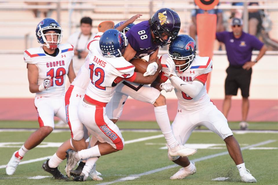 Wylie receiver Harrison Heighten (88) fights for extra yards after a catch while Cooper's Michael Ramis (12) and others try to make the tackle during last season's Southtown Showdown at Sandifer Stadium.