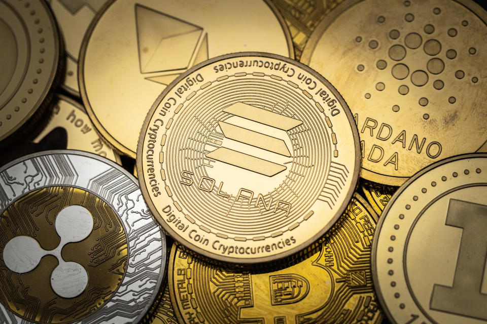 Solana SOL cryptocurrency physical coin on top of other cryptocurrencies.