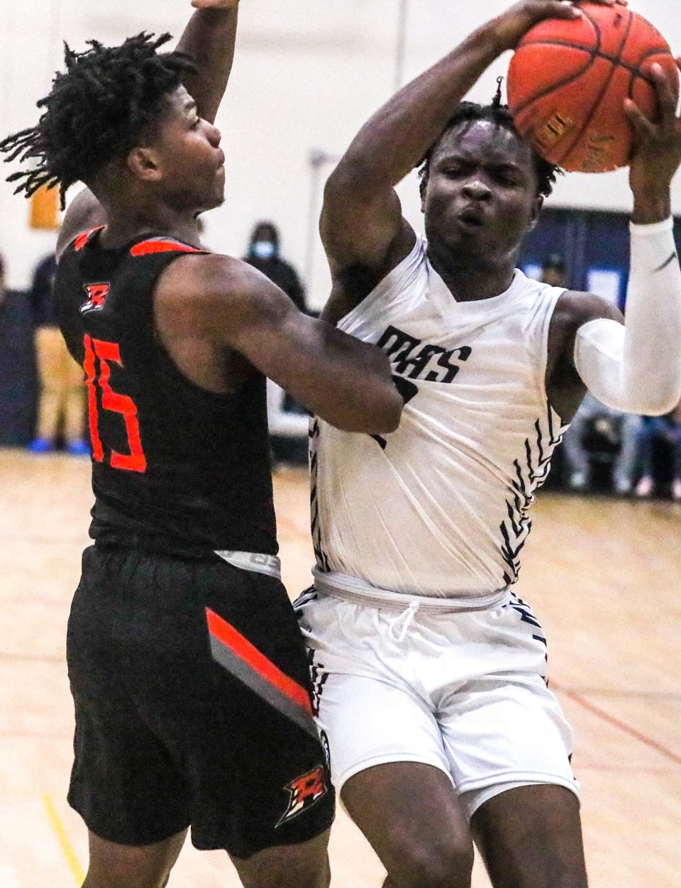 Milwaukee Academy of Science's Tayshawn Bridges drives to the basket as Riverside University's Carleone Turner guards him during their game Dec. 1. The Novas are the top-ranked team in Division 4.