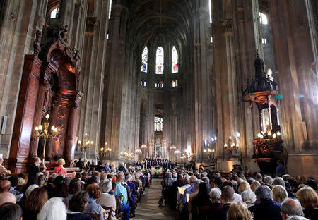 People attend Easter Sunday Mass at Saint-Eustache, days after a massive fire devastated large parts of the structure of the gothic Notre-Dame Cathedral, in Paris, France, April 21, 2019. REUTERS/Gonzalo Fuentes