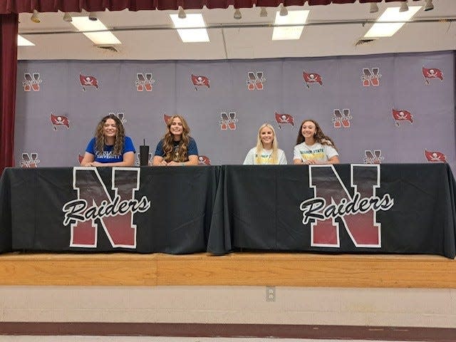 Navarre's Payton Provo, Cailyn Cooke, Jessica Farrer and Harmony Stafford pose for photos after signing letters on intent to continue their athletic careers in college during a ceremony on Wednesday, Nov. 9, 2022 from Navarre High School. Provo will cheer for Faulkner State Community College. Cooke will play softball for Gulf Coast State College. Farrer and Stafford are headed to Bishop State Community College.