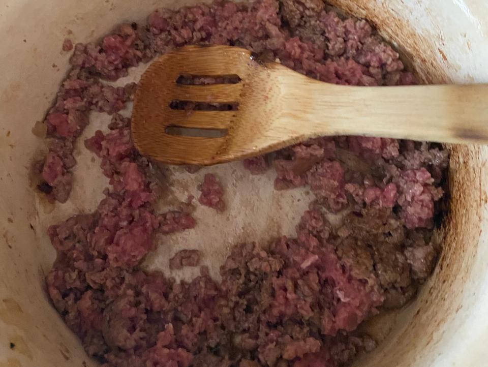 ground beef cooking in a pot on the stove