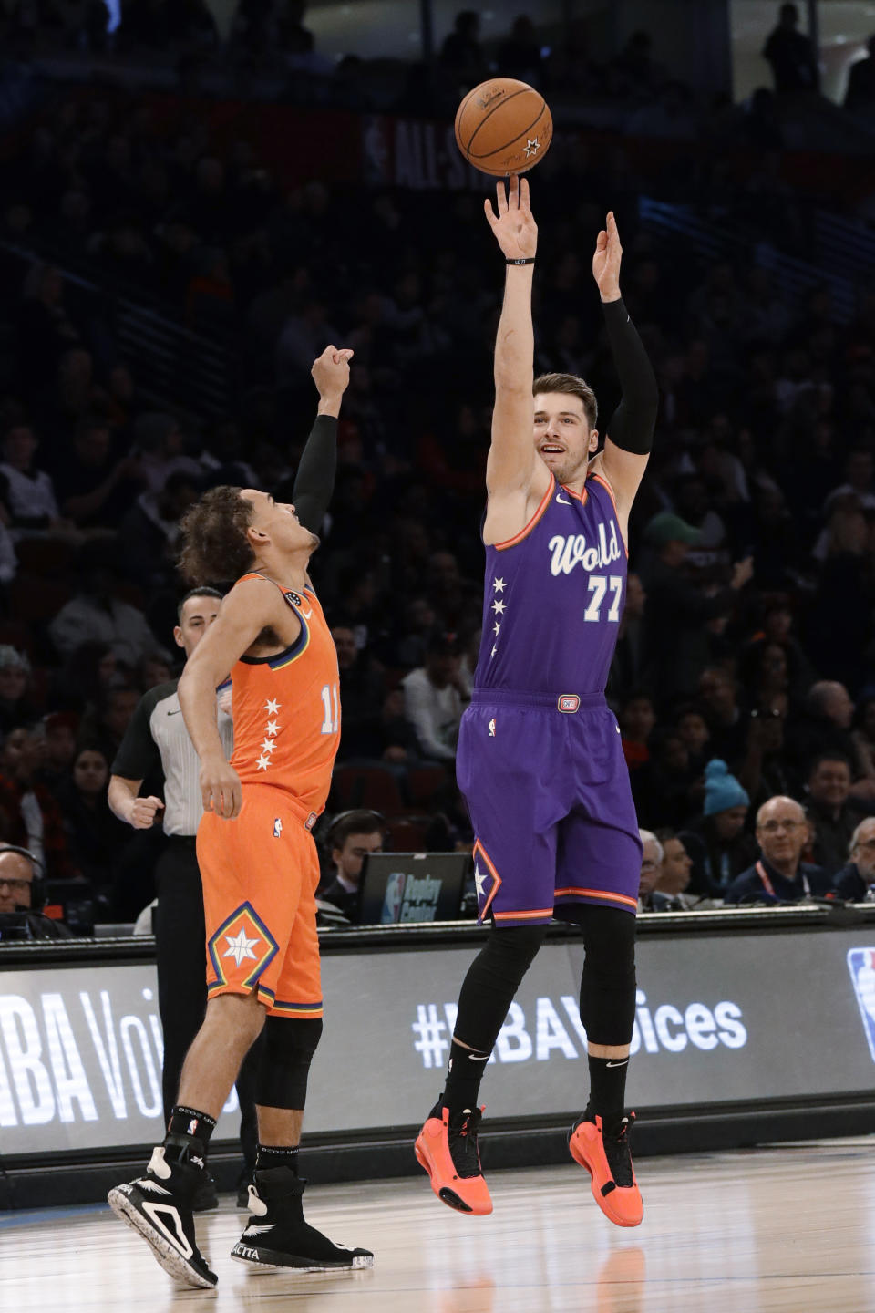 World's Luka Doncic, right, of the Dallas Mavericks, shoots over U.S. guard Trae Young, of the Atlanta Hawks, during the first half of the NBA Rising Stars basketball game in Chicago, Friday, Feb. 14, 2020. (AP Photo/Nam Y. Huh)