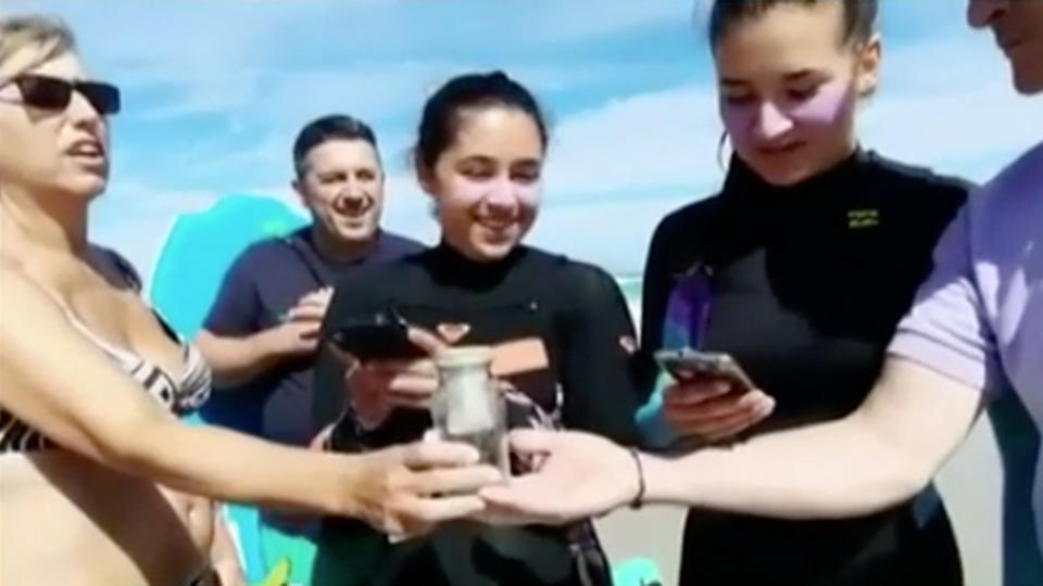 The Alvarez family from Spain holding the bottle of Jerry Whitt’s ashes