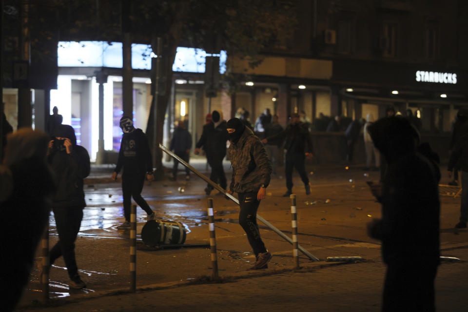 Bulgarian supporters clash with police during the Euro 2024 Bulgaria v Hungary soccer match, played at closed doors, in Sofia, Thursday, Nov. 16, 2023. Thousands of Bulgarian football supporters have taken to the streets of the capital, Sofia, in protest over the management of the national football union, a demonstration that eventually turned violent. The European soccer qualifier between Bulgaria and Hungary fell victim to a bitter dispute between the management of the Bulgarian Football Union and soccer fans from across the Balkan country. (AP Photo/Valentina Petrova)