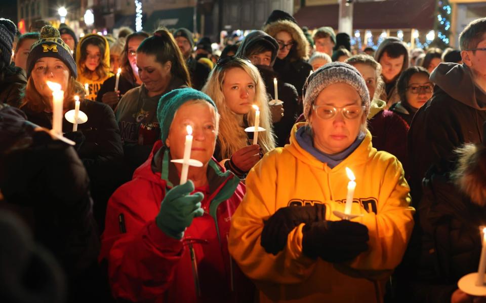 Mourners attend a vigil downtown to honour those killed and wounded during the recent shooting at Oxford High School, Michigan - Getty