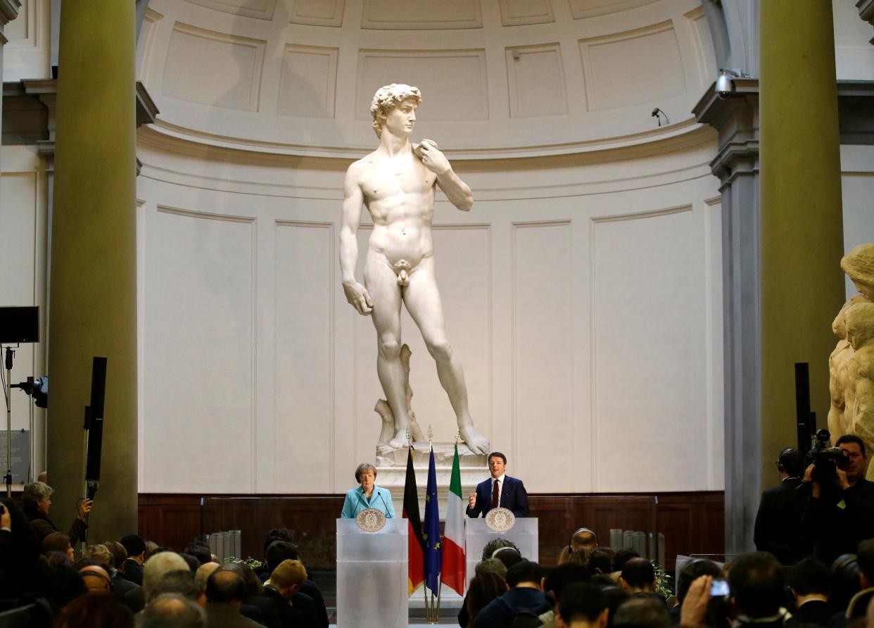 FILE - German Chancellor Angela Merkel, left, and Italian Prime Minister Matteo Renzi speak during a press conference in front of Michelangelo's "David statue" after their bilateral summit in Florence, Italy, on Jan. 23, 2015. The head of Florence’s Galleria del’Accademia on Sunday March 26, 2023 invited the parents and students of a Florida charter school to visit and see Michelangelo’s “David,” after the school principal was forced to resign following parental complaints that an image of the nude Renaissance masterpiece was shown to a sixth-grade art class. (AP Photo/Antonio Calanni, File)