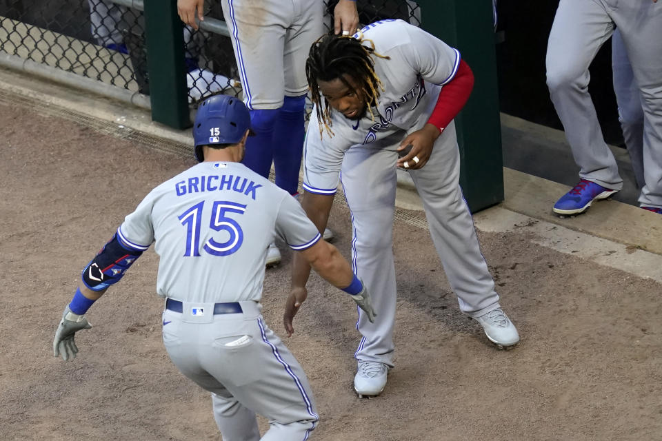 Toronto Blue Jays' Randal Grichuk celebrates his home run off Chicago White Sox starting pitcher Lance Lynn with Vladimir Guerrero Jr. during the second inning of a baseball game Wednesday, June 9, 2021, in Chicago. (AP Photo/Charles Rex Arbogast)