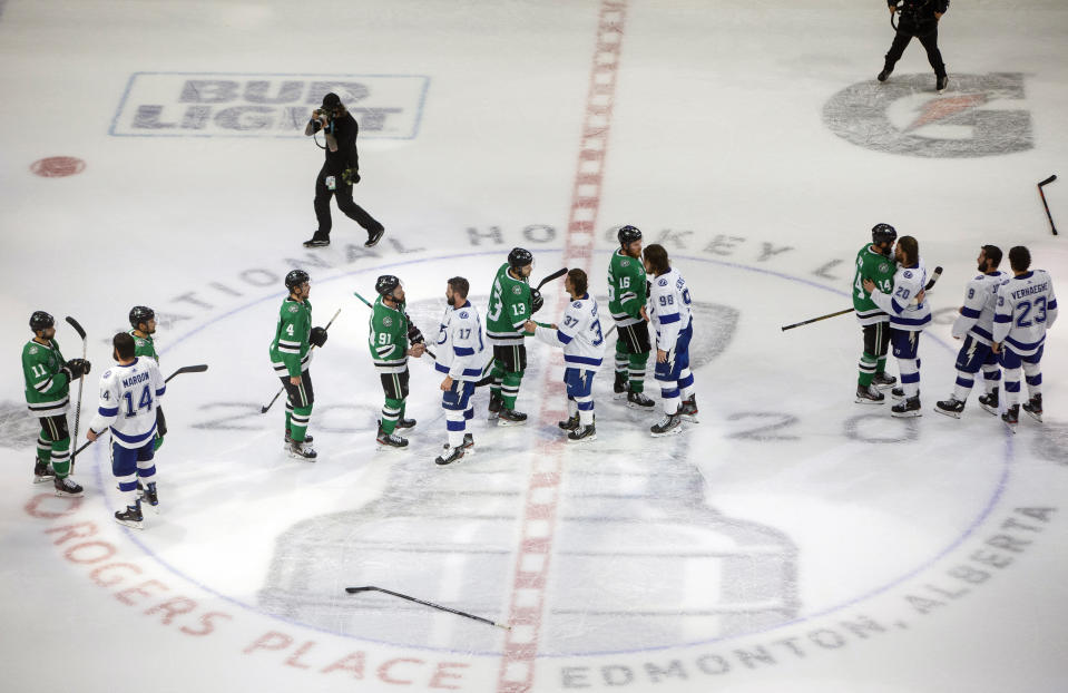 Tampa Bay Lightning and the Dallas Stars players shake hands after the Lightning win the Stanley Cup in the NHL Stanley Cup hockey finals, in Edmonton, Alberta, on Monday, Sept. 28, 2020. (Jason Franson/The Canadian Press via AP)