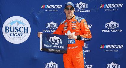 Brad Keselowski holds the Busch Light Pole Award banner after leading qualifying at Texas Motor Speedway