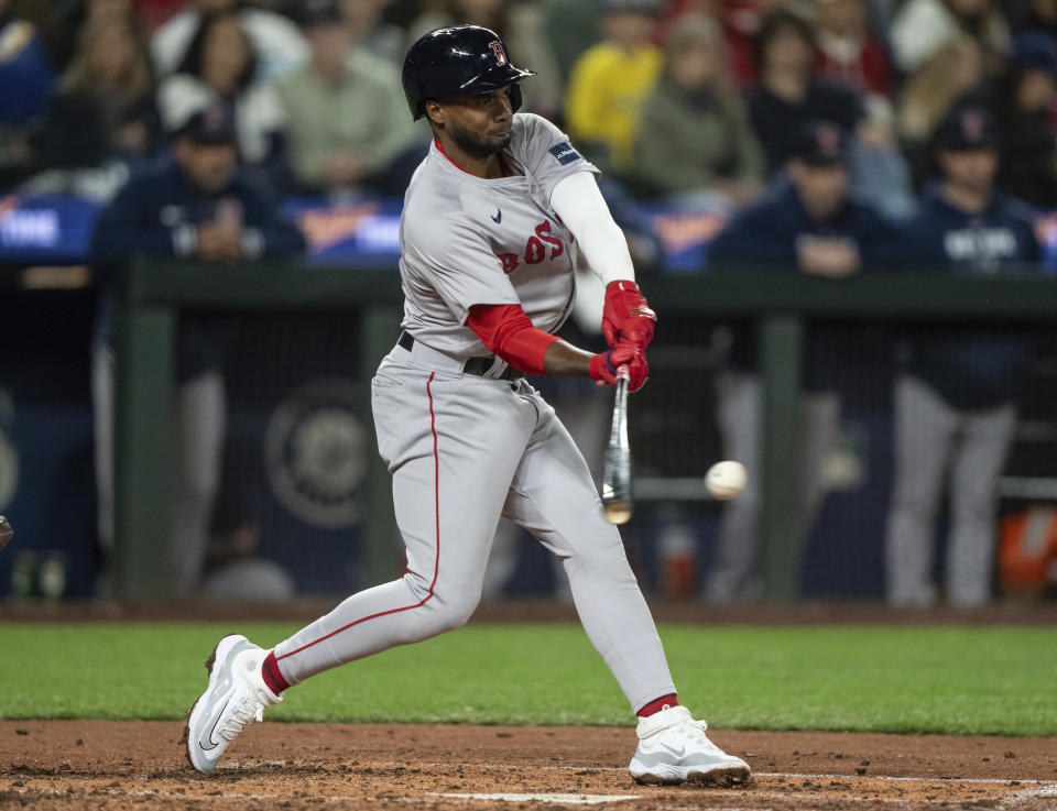 Boston Red Sox's Pablo Reyes grounds out to score Ceddanne Rafaela during the fifth inning of the team's baseball game against the Seattle Mariners, Saturday, March 30, 2024, in Seattle. (AP Photo/Stephen Brashear)