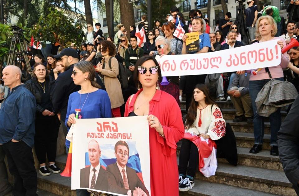 A protester holds a banner reading "no to Russian law" during a demonstration as the Georgian parliament considers the controversial "foreign agents law" outside the parliament in Tbilisi, Georgia on April 16, 2024. (Vano Shlamov/AFP via Getty Images)