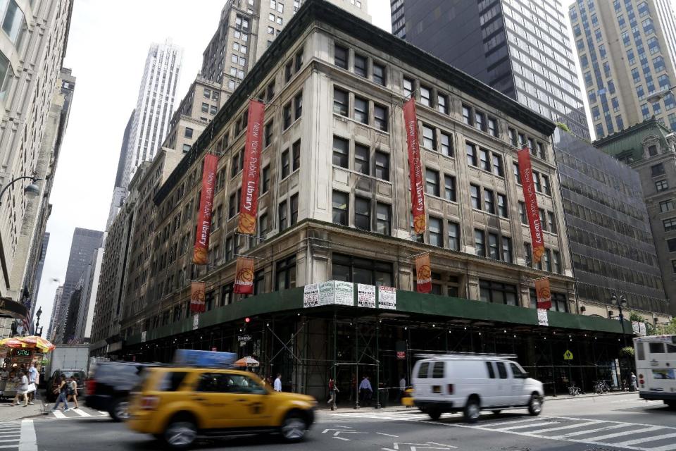 This Monday, July 22, 2013 photo shows the Mid-Manhattan Library in New York. Plans for a major change within the New York Public Library’s landmark main building have kindled an intellectual culture clash over its direction and the future of libraries themselves. (AP Photo/Seth Wenig)