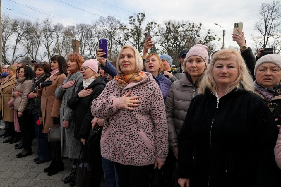 People sing the national anthem during a visit by Ukrainian President Volodymyr Zelensky (Copyright 2023 The Associated Press. All rights reserved)