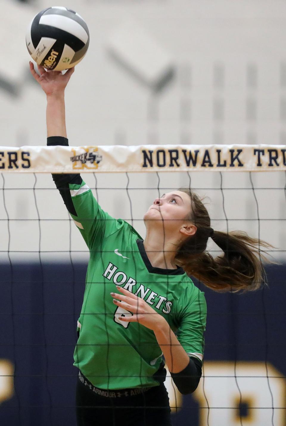 Highland's Izzy Shank hits the ball over the net during a Division I regional semifinal against Amherst on Nov. 3, 2022, in Norwalk.