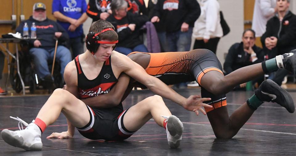 Hickory High School's Brody Bishop (left) wrestles Cathedral Prep's Amir Johnson in the District 10 Class 3A final at 121 pounds.