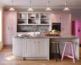 <b>Unexpected pop of colour</b><br><br>Who said you need bright colours to make a striking design statement? A surprise pop of pastel can be a sophisticated way to add interest. This <a href="http://www.john-lewis.co.uk/kitchen-ranges/shaker.php" rel="nofollow noopener" target="_blank" data-ylk="slk:Shaker kitchen;elm:context_link;itc:0;sec:content-canvas" class="link "><span>Shaker kitchen</span></a> from John Lewis of Hungerford features three shades of pink for a calm and elegant look. The grey marble worktops and splashback compliment the soft grey of the island unit and open shelving – which keep the room looking airy rather than confined.