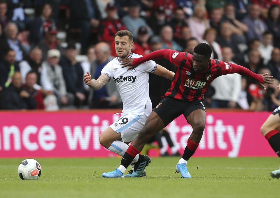 West Ham United's Jack Wilshere, left, and Bournemouth's Jefferson Lerma clash during their English Premier League soccer match at the Vitality Stadium in Bournemouth, England, Saturday, Sept. 28, 2019. (Mark Kerton/PA via AP)