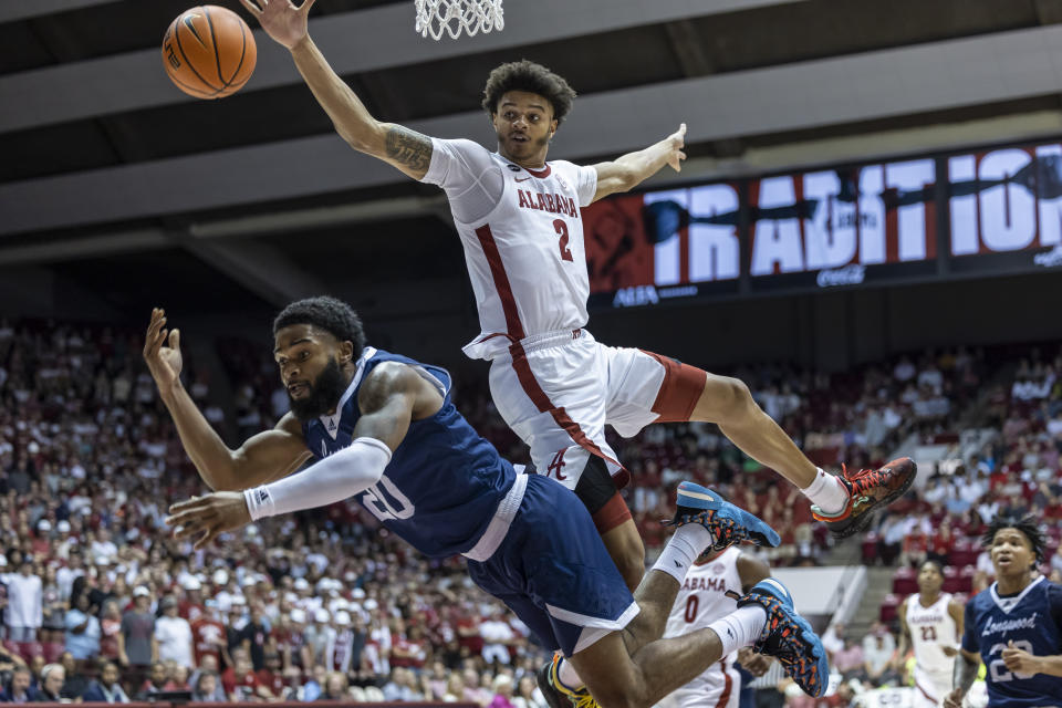 Longwood guard Walyn Napper (20) gets a shot off as Alabama forward Darius Miles (2) arrives on defense during the first half of an NCAA college basketball game Monday, Nov. 7, 2022, in Tuscaloosa, Ala. (AP Photo/Vasha Hunt)