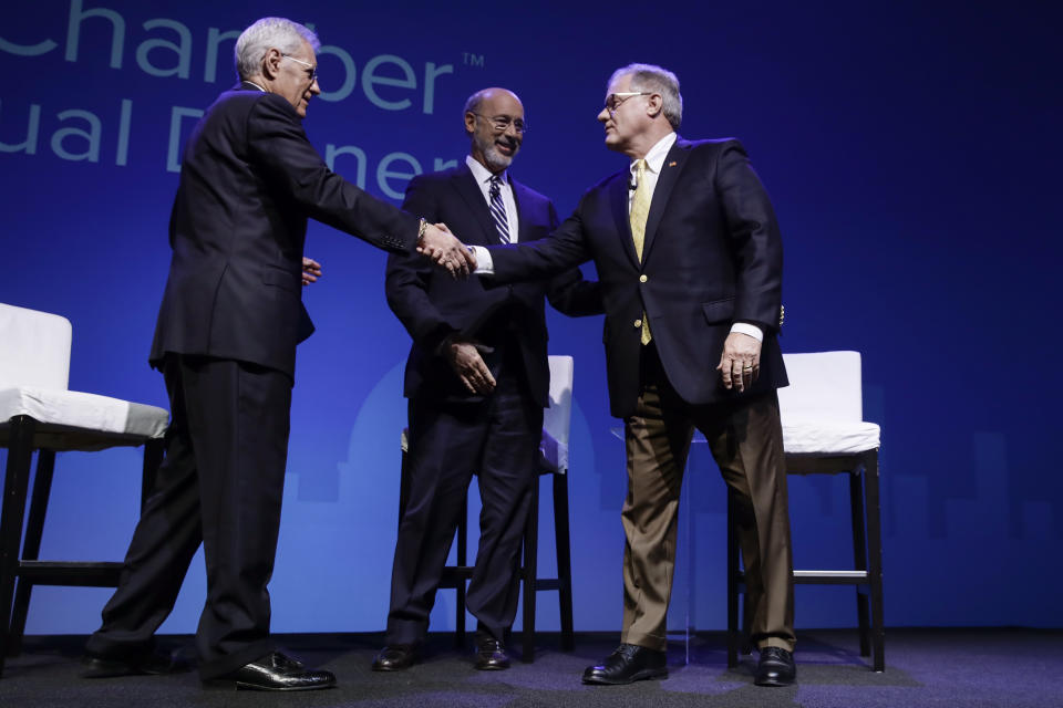 Republican Scott Wagner, right, shake hands with moderator Alex Trebek, left, as Democratic Gov. Tom Wolf, center, looks on at a gubernatorial debate in Hershey, Pa., Monday, Oct. 1, 2018. The debate is hosted by the Pennsylvania Chamber of Business and Industry. (AP Photo/Matt Rourke)
