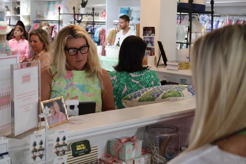 Colleen Orrico rings up a customer buying a Lilly Pulitzer item at her store C. Orrico during The Pink Retreat. Colleen and sister Casey Orrico shared memories of longtime friend Pulitzer during the "Spilling the Juice" event Friday morning.