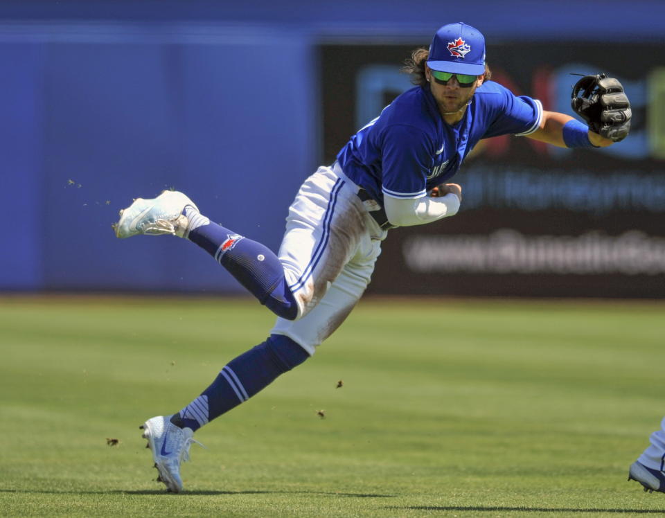 Toronto Blue Jays shortstop Bo Bichette makes a play on a ground ball hit by New York Yankees' Tyler Wade during the fifth inning of a spring training baseball game Sunday, March 14, 2021, at TD Ballpark in Dunedin, Fla. (Steve Nesius/The Canadian Press via AP)