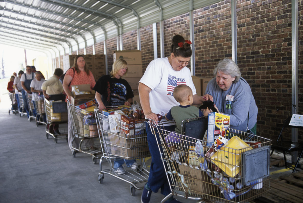 People stand in line with carts filled with groceries at the foodbank in McArthur, Ohio.