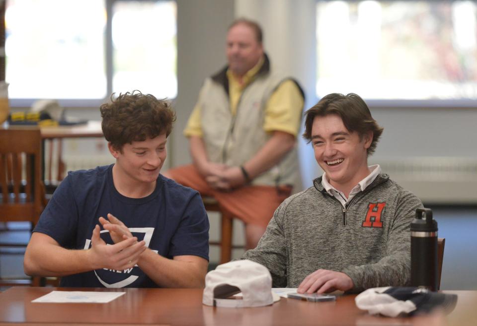 FALMOUTH -- 11/09/22 -- Rafe Grant, left, and Christopher Ledwick smile after their introduction and signing before, friends, teammates and family members. Grant is headed to Ithaca College and Ledwick to the University of Hartford. Both will play lacrosse. A celebratory ceremonial signing day was held at Falmouth High School for eight student athletes who are headed to college and will continue to play sports. Merrily Cassidy/Cape Cod Times