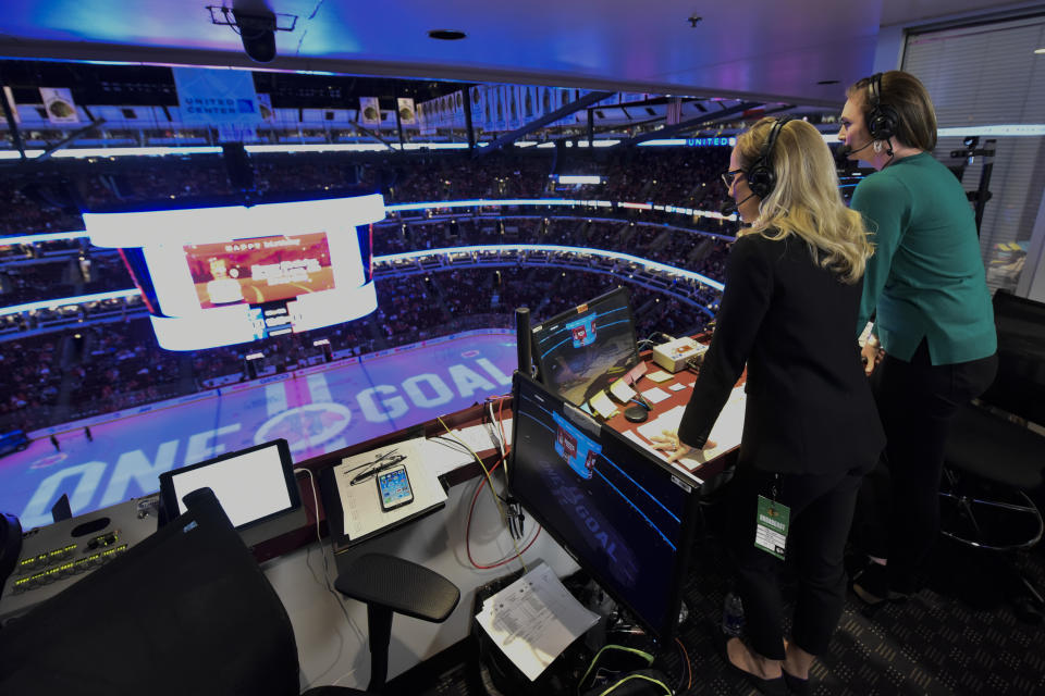 Kate Scott, left, and AJ Mleczko, members of an all-female broadcast team, work during an NHL hockey game between the Chicago Blackhawks and the St. Louis Blues, Sunday, March 8, 2020, in Chicago. They were doing this as part of International Women's Day. (AP Photo/Matt Marton)