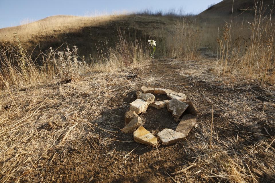 In a field of dry brush, rocks are arranged into a figure eight.