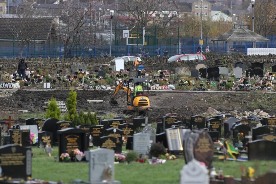 Workers use machinery to dig graves next to the Muslim burial ground at the Scholemoor Cemetery and Crematorium, in Bradford, West Yorkshire (Danny Lawson/PA) (PA Archive)